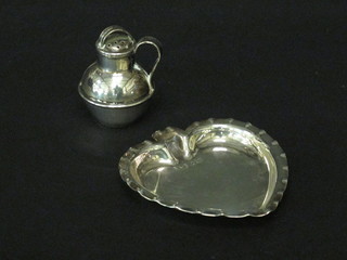 An Edwardian silver miniature pepperette in the form of a Jersey milk canister Birmingham 1901 together with a silver heart  shaped pin tray Birmingham 1897