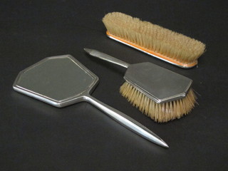 A silver backed 3 piece dressing table set with hand mirror,  hairbrush and clothes brush with engine turned decoration