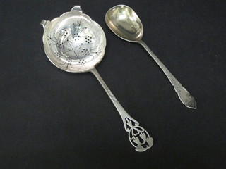 A silver tea strainer Sheffield 1934 and a silver jam spoon, Sheffield 1933