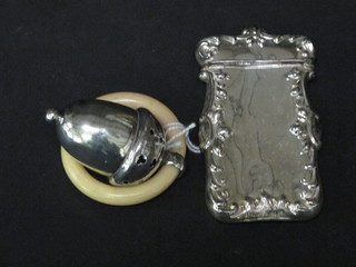 A silver rattle in the form of an acorn together with a Continental  Sterling vesta case