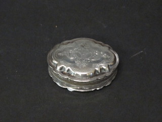 An oval Continental white metal trinket box with engraved decoration and hinged lid