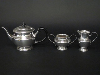 A circular 3 piece silver plated tea service with teapot, twin  handled sugar bowl and cream jug