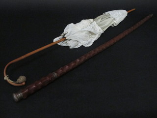 A tippling stick, glass missing, together with a parasol
