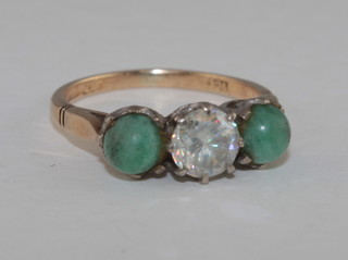 A gold dress ring set a white stone supported by 2 turquoise