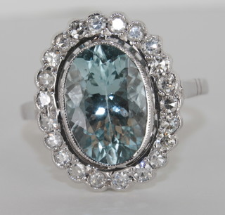 A lady's 18ct white gold dress ring set an oval aquamarine  supported by diamonds, approx 2.25ct/0.50ct