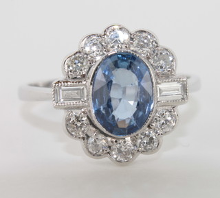 A lady's 18ct white gold dress ring set an oval cut sapphire  surrounded by diamonds, approx 1.40/0.63ct