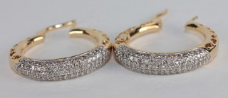 A pair of 18ct gold hoop earrings set diamonds, approx. 1ct
