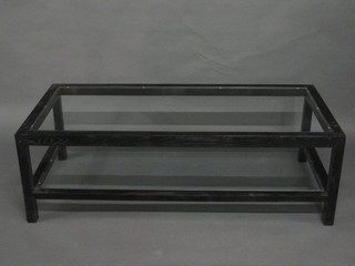 A rectangular ebonised coffee table with plate glass top 51"