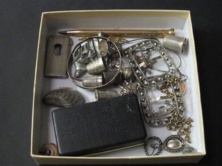 A silver money clip, various thimbles etc