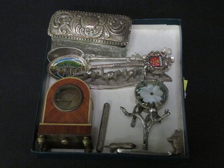 A silver ornament in the form of 2 birds, a rectangular cut glass dressing table jar with silver lid, a small collection of curios