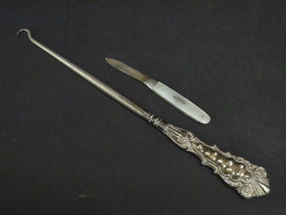 A silver bladed fruit knife with mother of pearl grip and a silver handled button hook
