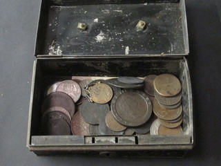 A collection of coins contained in a small metal box