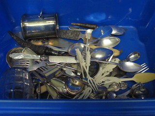A blue crate containing a collection of silver plated flatware,  ivory forks etc