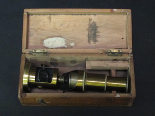 A student's brass single pillar microscope together with a set of scales