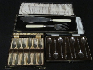 A pair of silver plated fish servers, a set of 6 silver plated fish forks, a set of 6 silver plated apostle spoons and tongs, all cased