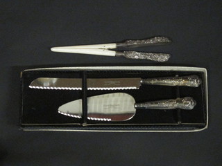 A silver handled cake slice, do. bread knife and a pair of glove stretchers