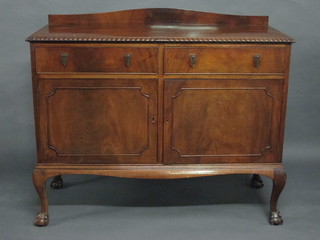 A 1930's Chippendale style mahogany sideboard with raised back  and gadrooned border fitted 2 long drawers above a double  cupboard, raised on cabriole ball and claw supports 48"