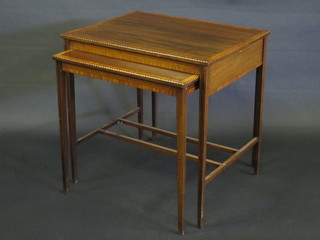 A rectangular inlaid mahogany occasional table with crossbanded top, the base incorporating 2 side tables, raised on square  tapering supports 27"