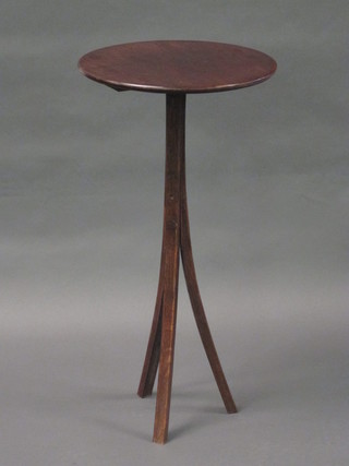 An Edwardian circular mahogany wine table raised on  outstretched supports 13"