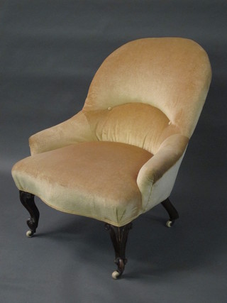 A Victorian mahogany framed armchair upholstered in mushroom material raised on French cabriole supports