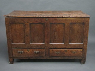 A 17th/18th Century oak coffer of panelled construction with hinged lid, the base fitted 2 drawers 49"   ILLUSTRATED