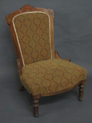 A Victorian inlaid walnut nursing chair with upholstered seat and  back, raised on turned supports