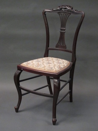 A Victorian mahogany bedroom chair with pierced vase shaped slat back and upholstered seat, raised on cabriole supports