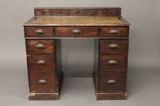 A Victorian pine kneehole pedestal desk with raised super structure to the back, fitted 5 short drawers with inset writing  surface above 3 long drawers, the base fitted 6 short drawers 43"