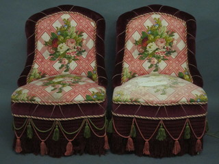 A pair of Victorian mahogany framed nursing chairs upholstered  in red and floral patterned material