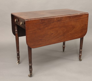 A 19th Century Pembroke table fitted a frieze drawer and raised  on reeded supports ending in brass caps and castors 36"