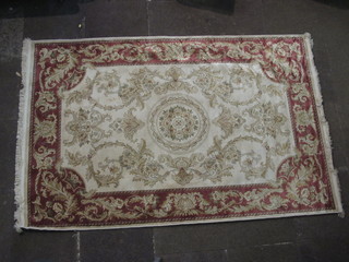An Abusson style beige ground patterned carpet 90" x 57"