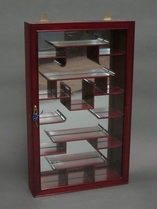 An Oriental hardwood hanging display cabinet with mirrored  back, the interior fitted shelves enclosed by a glazed panelled  door 18"