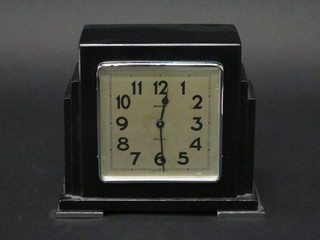 An Art Deco 8 day mantel clock with silvered dial and Arabic  numerals contained in a black painted metal case by Bayard