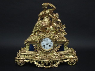 A 19th Century French 8 day striking clock contained in a gilt metal case surmounted by a figure of Cupid 18"   ILLUSTRATED