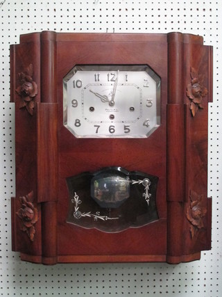 A French Art Deco chiming wall clock with lozenge shaped  silver dial with Arabic numerals contained in a walnut case 20"