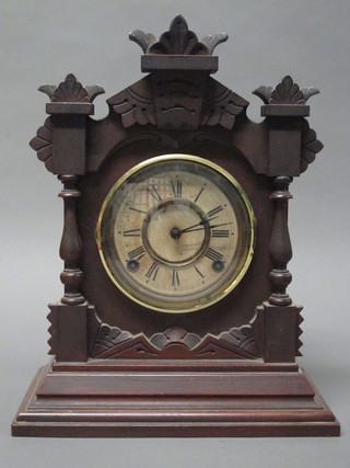An American shelf clock with Roman numerals contained in a  pine case by Ansonia