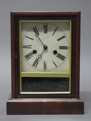 A German striking mantel clock with painted dial and Roman  numerals contained in a walnut case