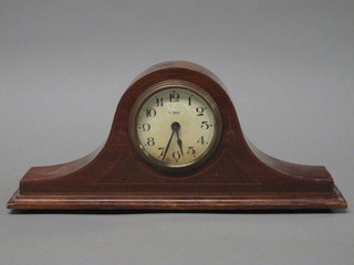 An 8 day bedroom timepiece with enamelled dial and Arabic numerals contained in an inlaid mahogany Admiral's hat shaped  case