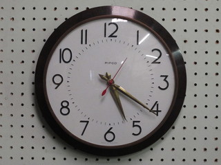 A wall clock with white dial and Arabic numerals contained in a  brown Bakelite case by Pithco 10"