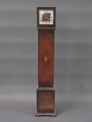 An Art Deco chiming Granddaughter clock with square dial and silvered chapter ring, contained in an oak case 49"