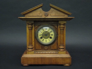 A Continental striking bracket alarm clock with Roman numerals contained in a walnut case 12"