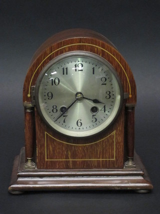 An Edwardian striking mantel clock with silvered dial and Arabic numerals contained in an arch shaped case 7 1/2"