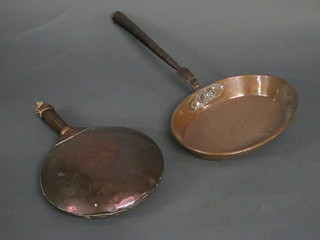 A circular copper warming pan and a 19th Century oval copper saucepan with iron handle