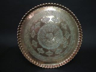 A circular Eastern embossed copper charger 22"