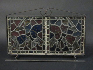 A wrought iron and stained glass decorative screen decorated Knights 20"