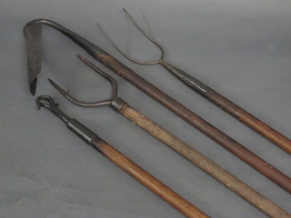 2 iron pitch forks, a trenching tool and 1 other item