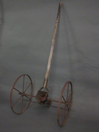 A wooden and iron seed drill