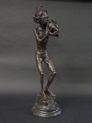 A large bronze figure of a Pixie blowing a shell, raised on a  circular marble base 33"