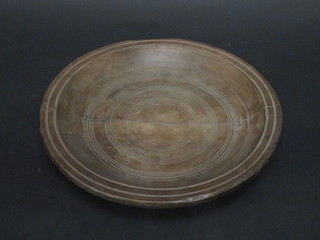 A circular turned wooden plate 30"