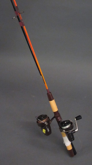 A Shakespeare 1411-153 carbon fibre fishing rod complete with  reel and a Viking fishing rod complete with reel